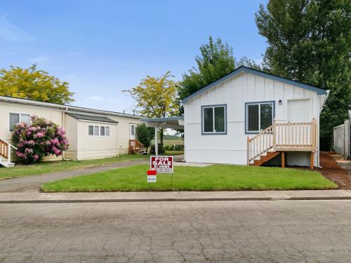 A mobile home for sale in a residential neighborhood.
