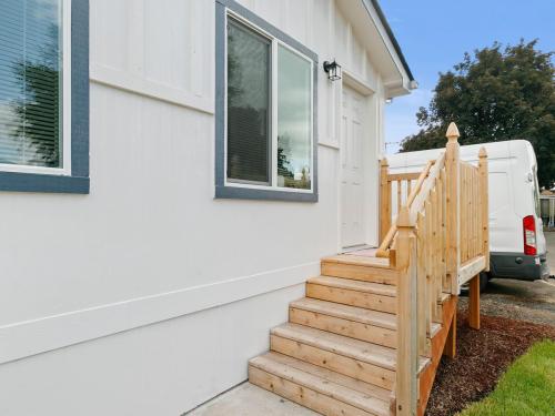 A white mobile home with stairs leading up to the front door.